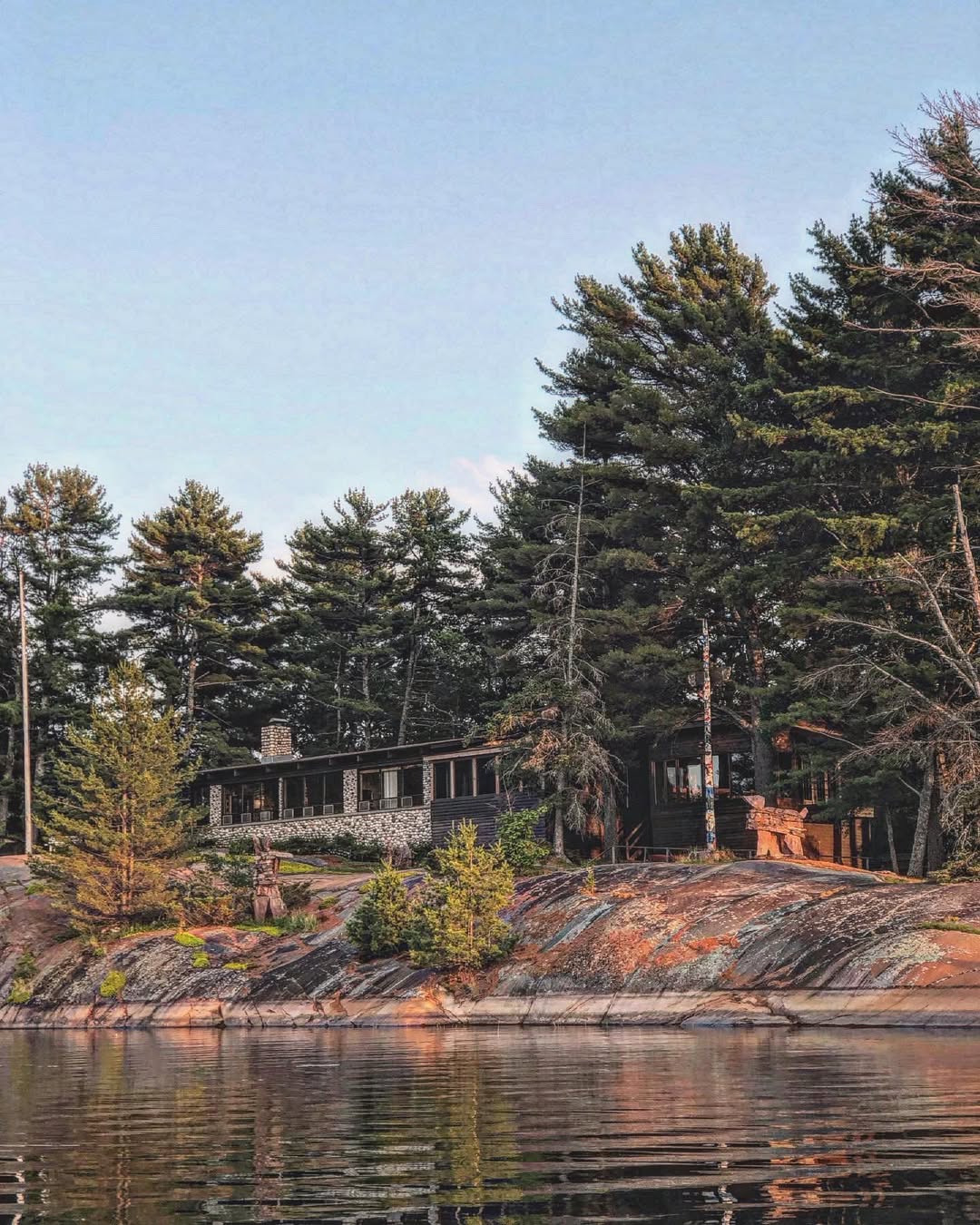 Shebanoning Main Lodge viewed from Georgian Bay showing pink granite shoreline