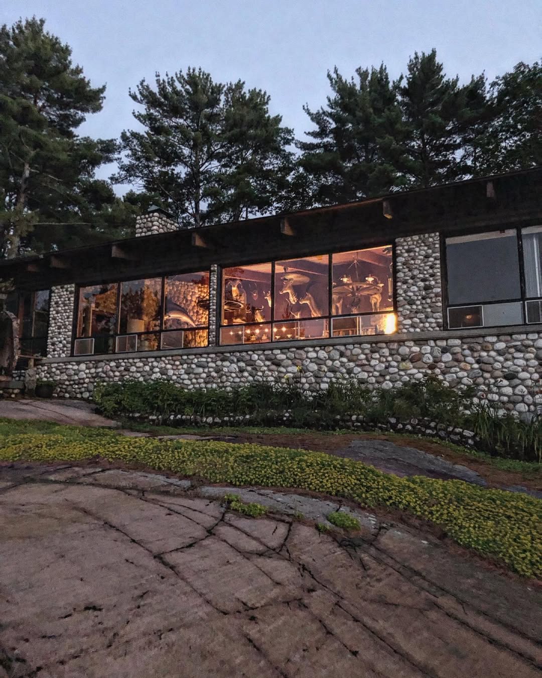 Shebanoning Main Lodge at dusk with warm interior lights